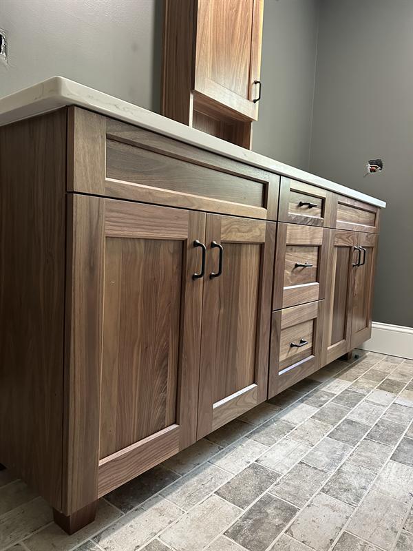 Walnut double bathroom vanity with a center drawer stack