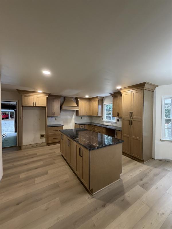 Natural wood kitchen cabinets with a center island